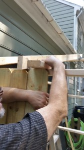 this is the trick we used to make sure pickets were level with top of frame-just take a piece of 2x4 and lay it on top and hold tight and line up the picket and nail